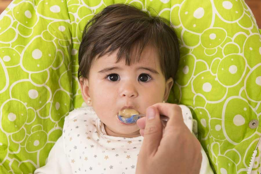 Baby being spoon fed